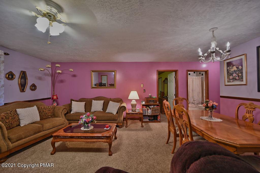 1607 Cotswald Road Tobyhanna, PA 18466 - Photo 9 of 61 a living room with furniture a chandelier and a chandelier