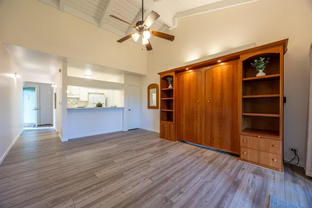 a view of an empty room with a kitchen