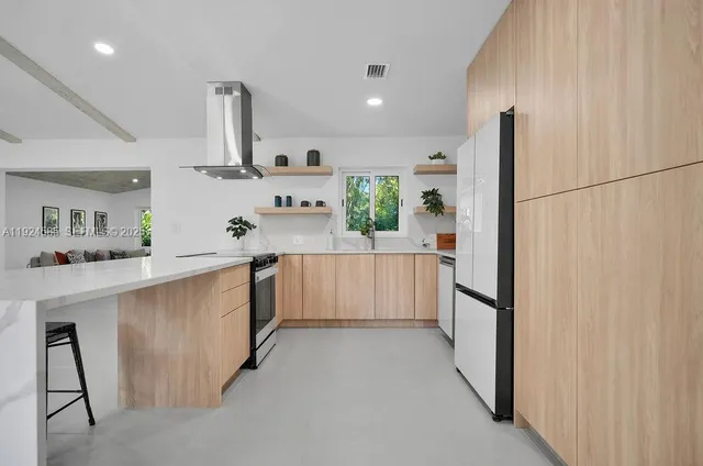 a kitchen with stainless steel appliances a refrigerator sink and cabinets