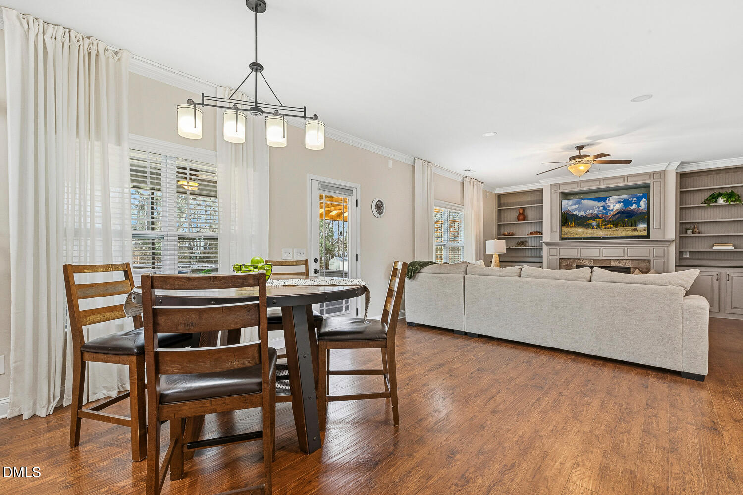 5933 Rounder Lane Holly Springs, NC 27540 - Photo 13 of 45 a living room with a dining table wooden floor and a chandelier