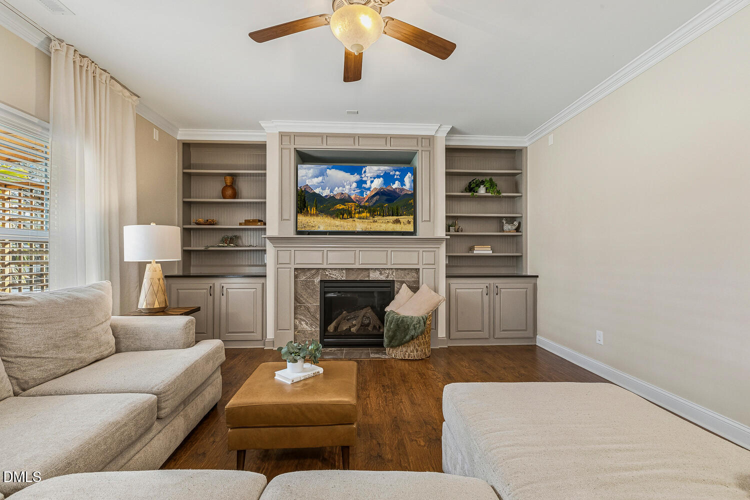 5933 Rounder Lane Holly Springs, NC 27540 - Photo 15 of 45 a living room with furniture a fireplace and a flat screen tv