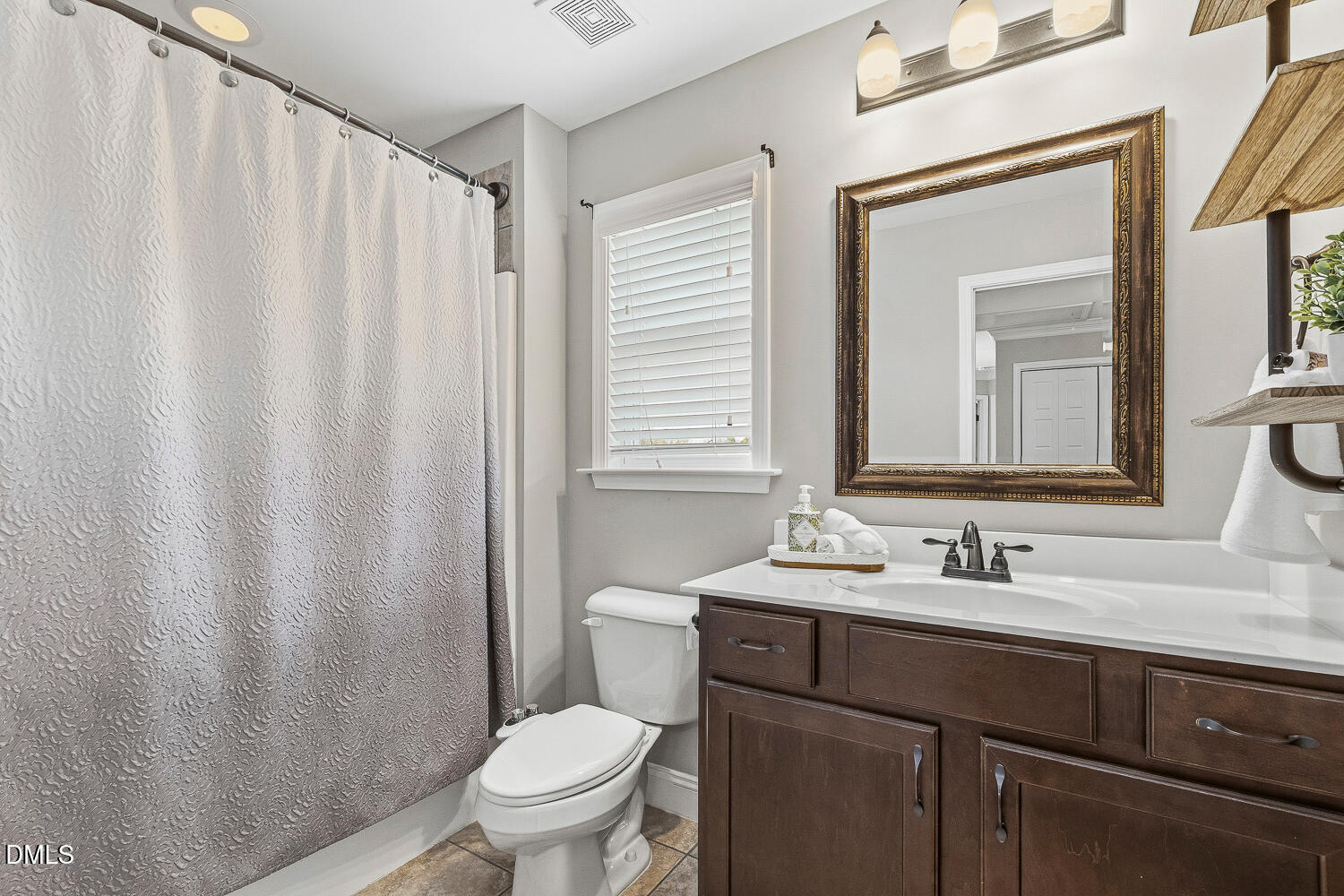 5933 Rounder Lane Holly Springs, NC 27540 - Photo 31 of 45 a bathroom with a sink a toilet and a mirror