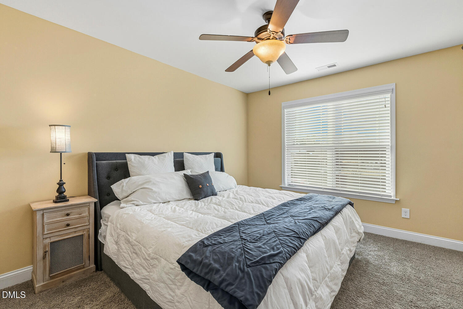 5933 Rounder Lane Holly Springs, NC 27540 - Photo 32 of 45 a bedroom with a large bed and a chandelier