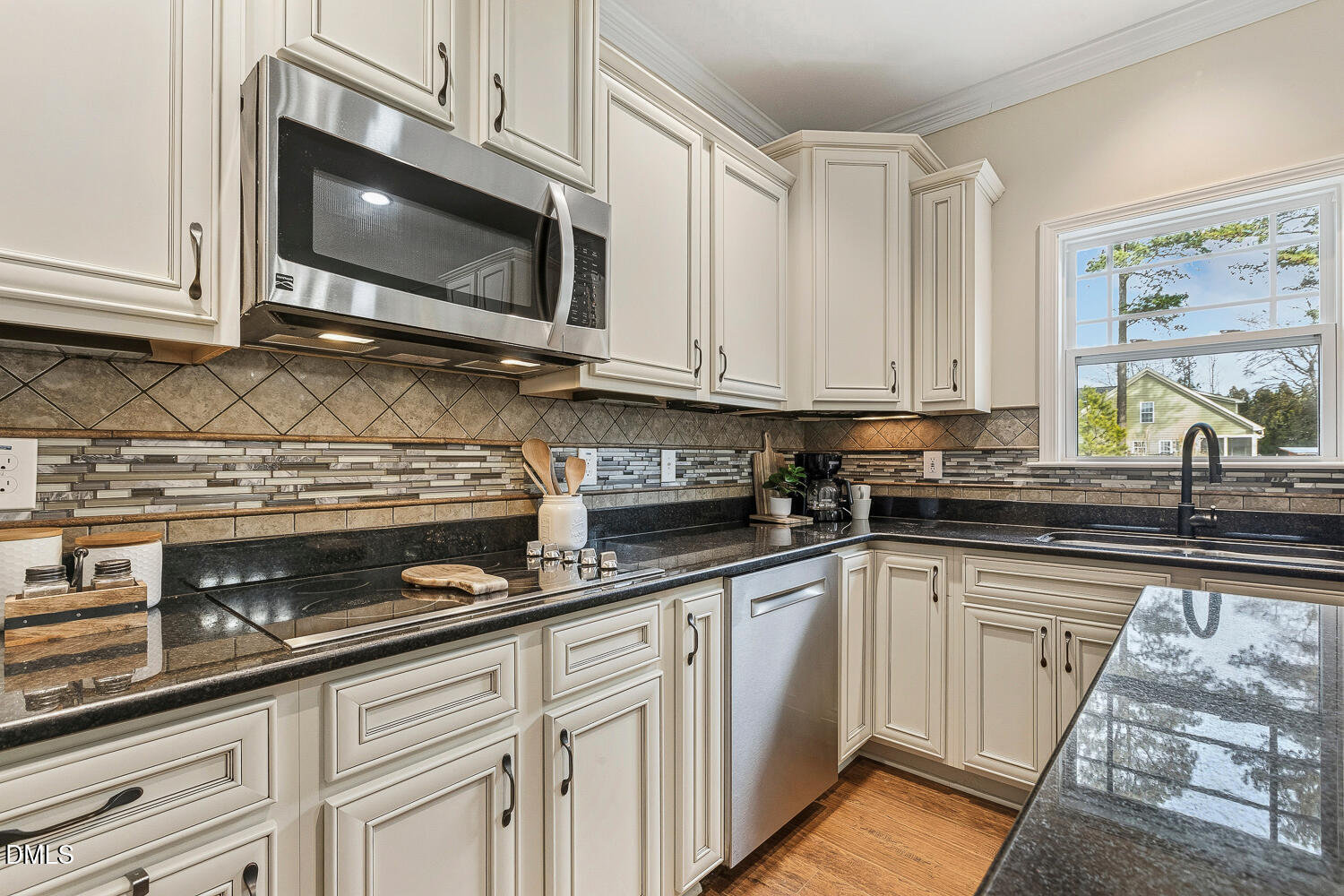 5933 Rounder Lane Holly Springs, NC 27540 - Photo 7 of 45 a kitchen with stainless steel appliances granite countertop a sink a stove and microwave