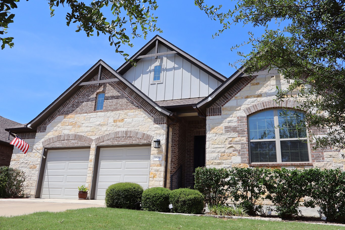 A charming home presents a striking facade with mixed materials and thoughtful architectural details.
