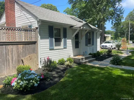 a view of a house with a backyard and sitting area