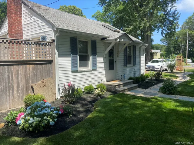 a view of a house with a backyard and sitting area