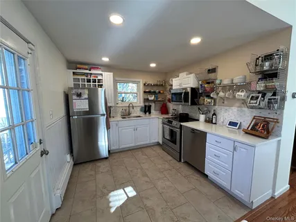 a kitchen with refrigerator and cabinets