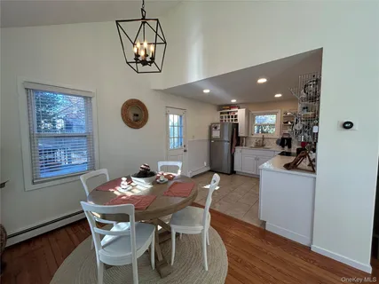 a view of a dining room with furniture wooden floor and a chandelier