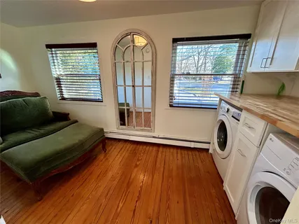 a bedroom with a bed and a exposed radiator with wooden floor
