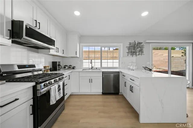 a kitchen with stainless steel appliances granite countertop a stove and a sink