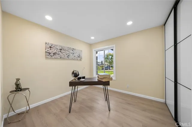 a view of a workspace with furniture and a window