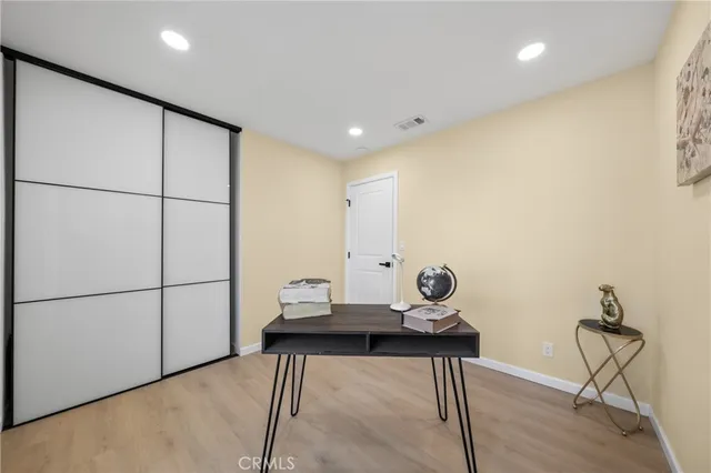 a view of a hallway with table and chairs