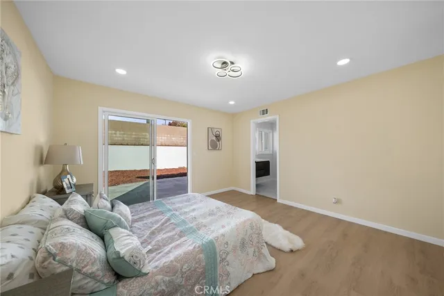 a spacious bedroom with a bed and a window