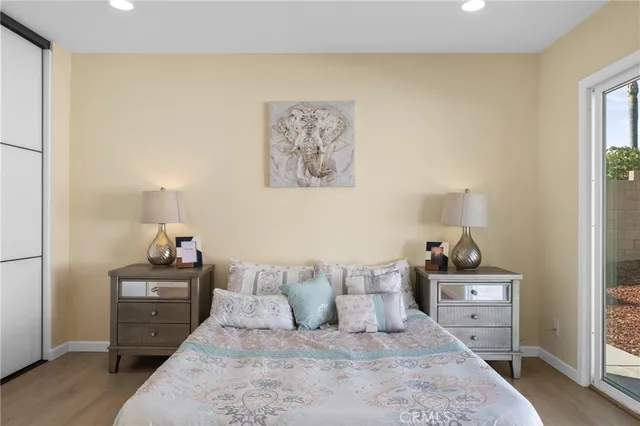 a bedroom with a bed and a night stand