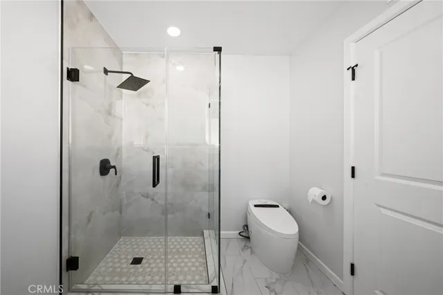 a bathroom with a shower toilet and a shower