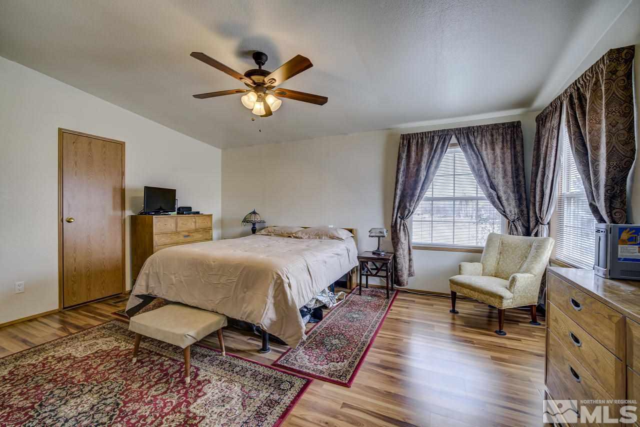 600 Theobald Reno, NV 89521 - Photo 13 of 25 a spacious bedroom with a bed and a large window