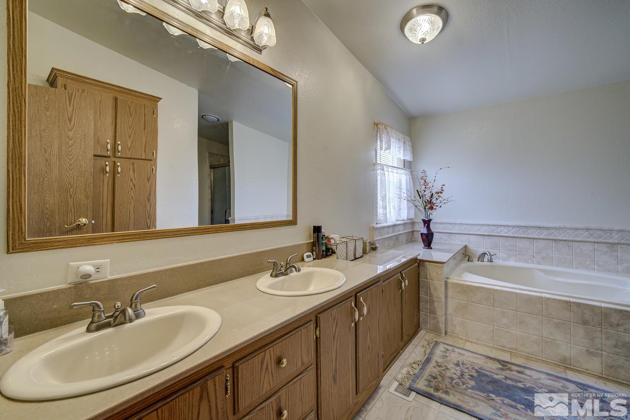 600 Theobald Reno, NV 89521 - Photo 14 of 25 a bathroom with a double vanity sink and a mirror