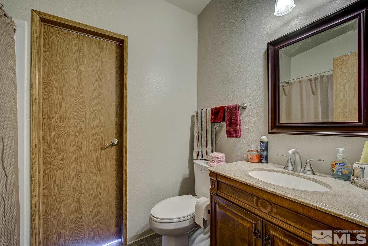 600 Theobald Reno, NV 89521 - Photo 18 of 25 a bathroom with a granite countertop sink toilet and mirror