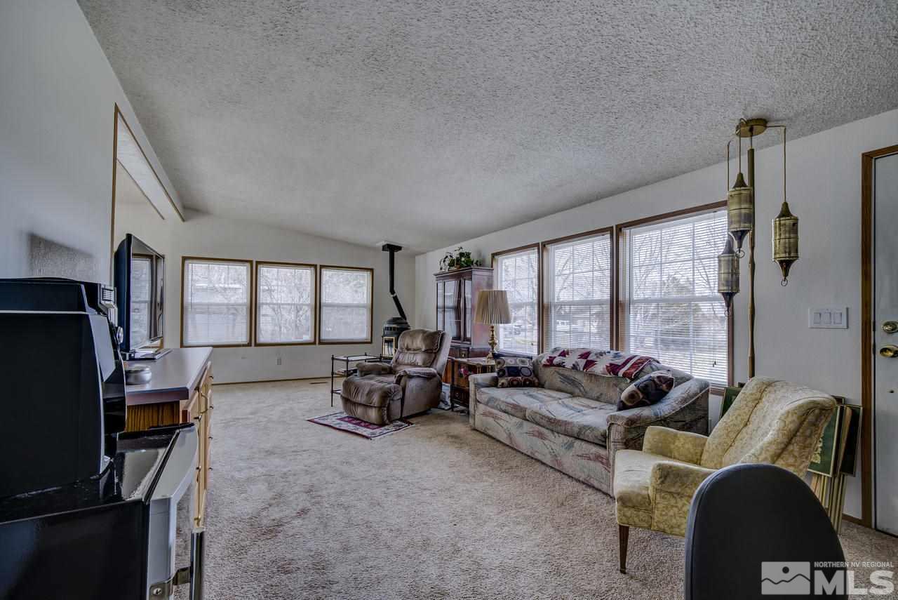 600 Theobald Reno, NV 89521 - Photo 7 of 25 a living room with furniture fireplace and large windows