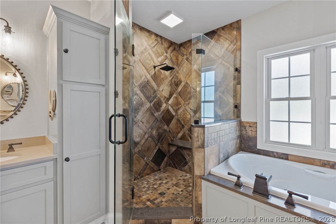 30180 East Lake Road Wagram, NC 28396 - Photo 25 of 42 a bathroom with a bathtub and a shower