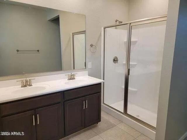 a bathroom with a double vanity sink and mirror