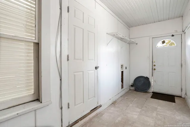 a view of a closet area with staircase
