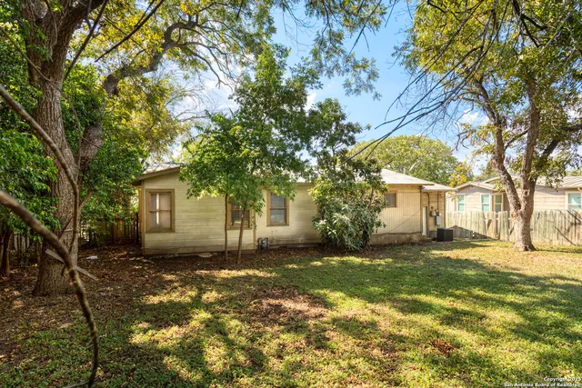 a view of a yard with a house and a tree