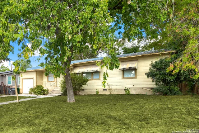 a view of a house with a yard