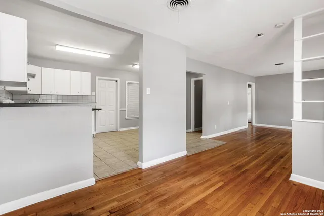 a view of a kitchen cabinets and wooden floor