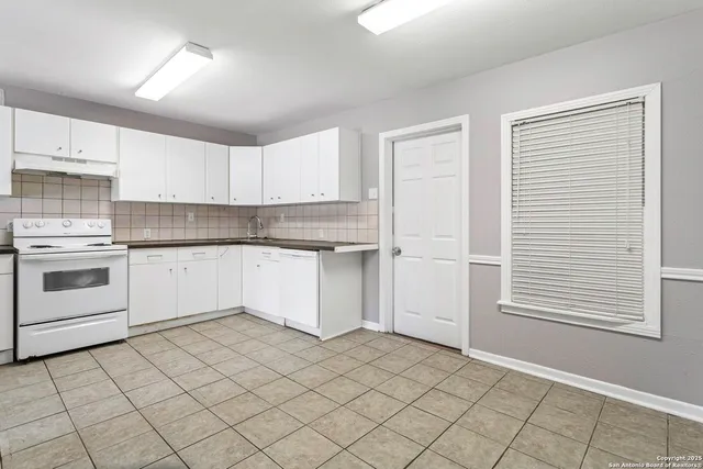 a kitchen with a stove a sink and a refrigerator