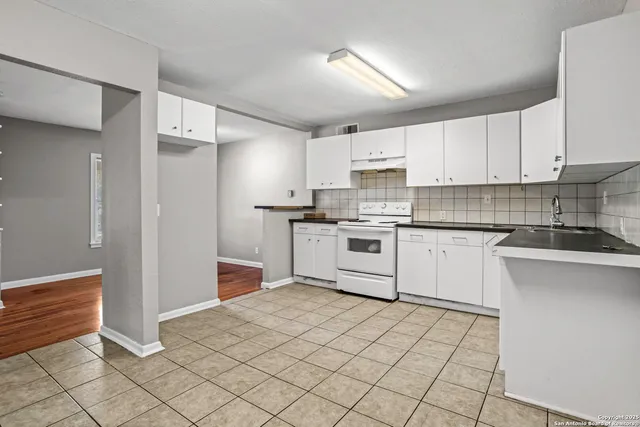 a kitchen with stainless steel appliances granite countertop a refrigerator sink and cabinets