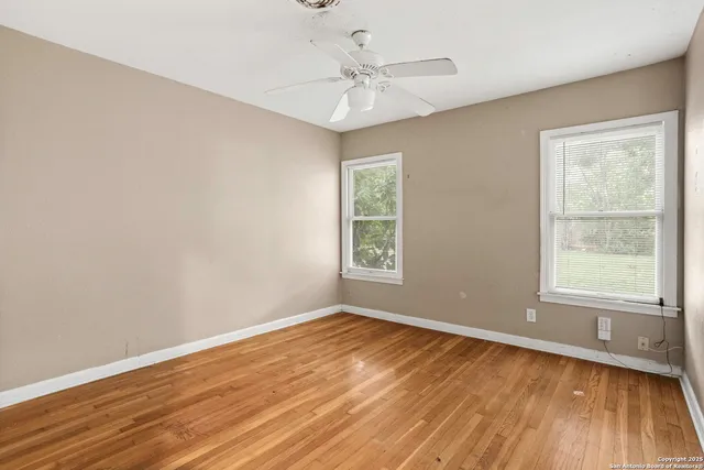 wooden floor in an empty room with a window