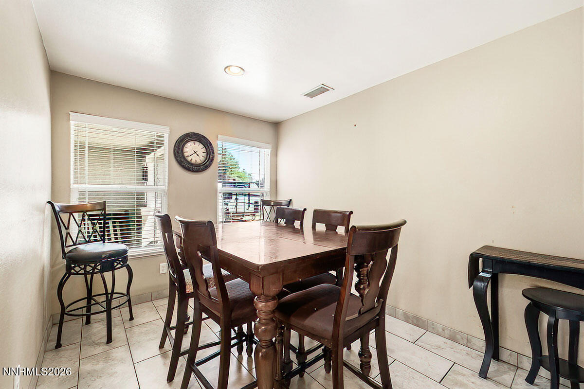 11365 Torino Way Reno, NV 89521 - Photo 17 of 29 a view of a dining hall with furniture and a clock