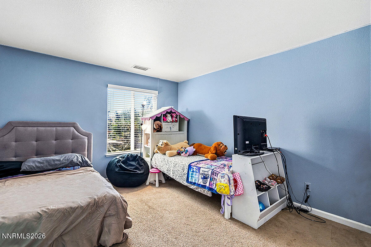 11365 Torino Way Reno, NV 89521 - Photo 22 of 29 a bedroom with two beds and a tv