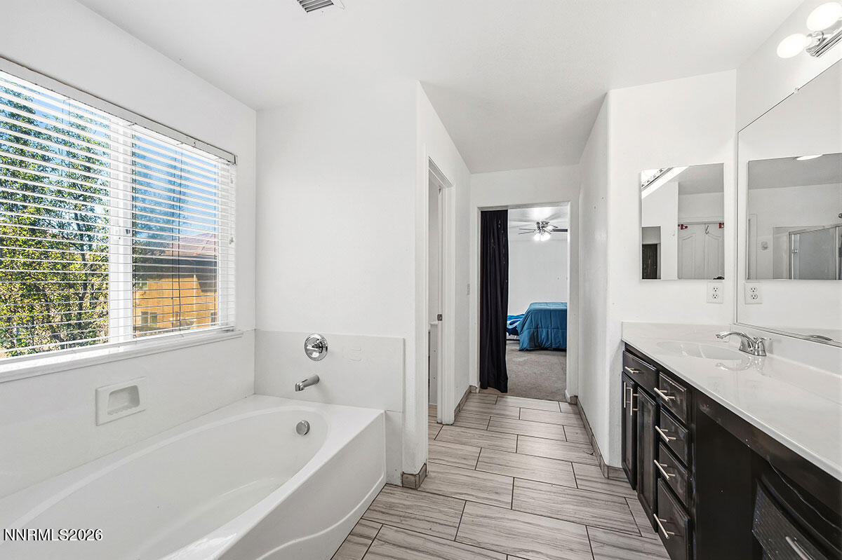 11365 Torino Way Reno, NV 89521 - Photo 26 of 29 a spacious bathroom with a tub sink and mirror
