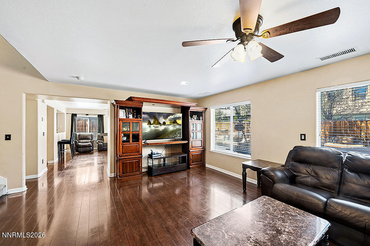 11365 Torino Way Reno, NV 89521 - Photo 7 of 29 a living room with furniture and a flat screen tv with wooden floor