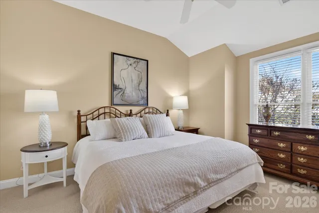 a bedroom with a bed and a night stand