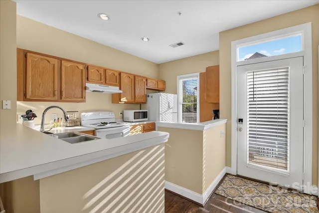 a kitchen with a sink stove and cabinets