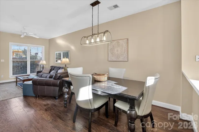 a living room with furniture a window and dining table