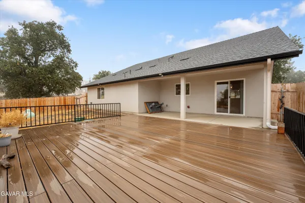 a view of a terrace with wooden floor and fence and a floor to ceiling window