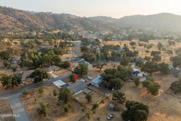 an aerial view of a house with a mountain