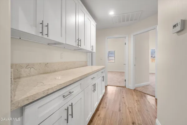 a view of a kitchen with wooden floor