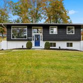 a front view of a house with a garden