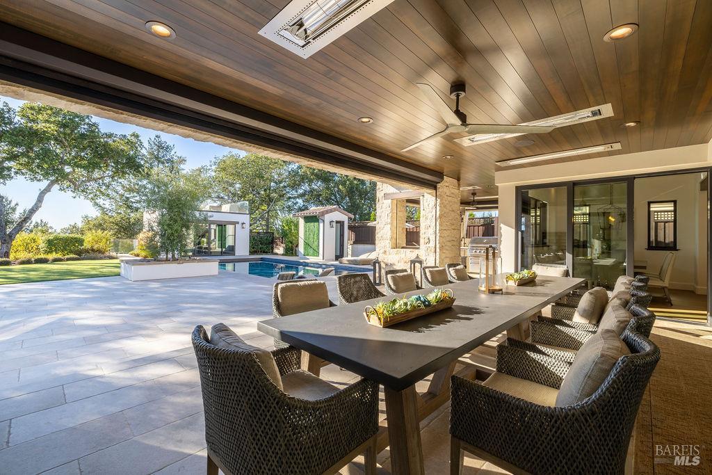 3981 Parker Hill Road Santa Rosa, CA 95404 - Photo 16 of 43 a view of a patio with a dining table and chairs