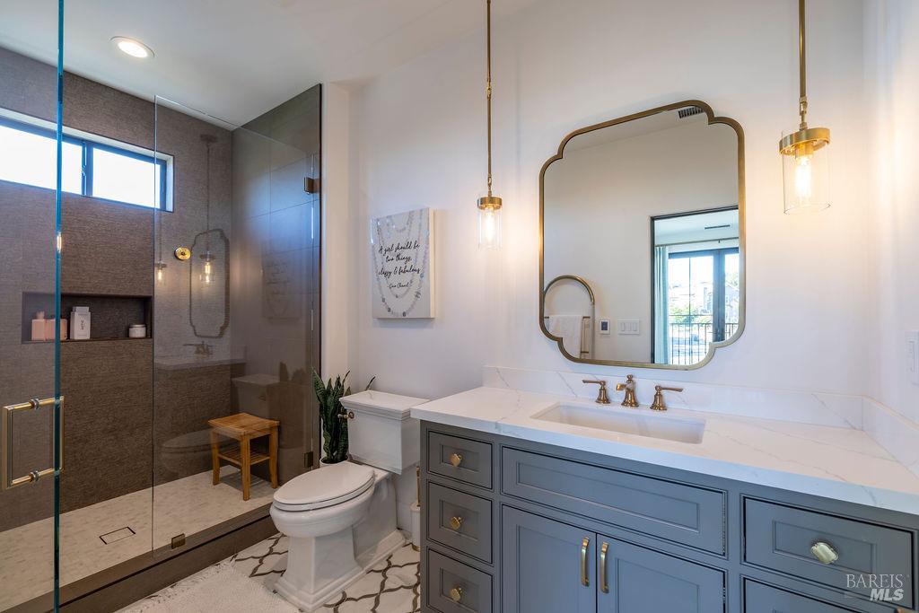 3981 Parker Hill Road Santa Rosa, CA 95404 - Photo 26 of 43 a bathroom with a toilet sink and mirror