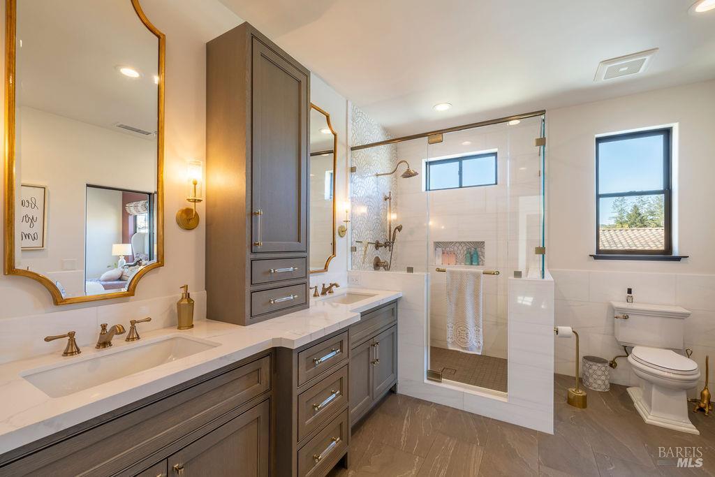 3981 Parker Hill Road Santa Rosa, CA 95404 - Photo 28 of 43 a spacious bathroom with a double vanity sink mirror and toilet