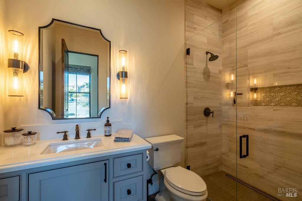 3981 Parker Hill Road Santa Rosa, CA 95404 - Photo 30 of 43 a bathroom with a granite countertop sink toilet a mirror and shower