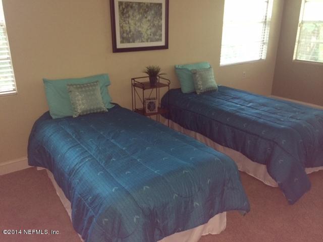 4052 Dover Road Jacksonville, FL 32207 - Photo 14 of 14 a bed sitting in a bedroom next to a window