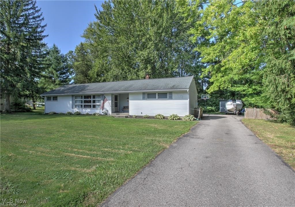 Single story home with a front lawn, central AC, and fence